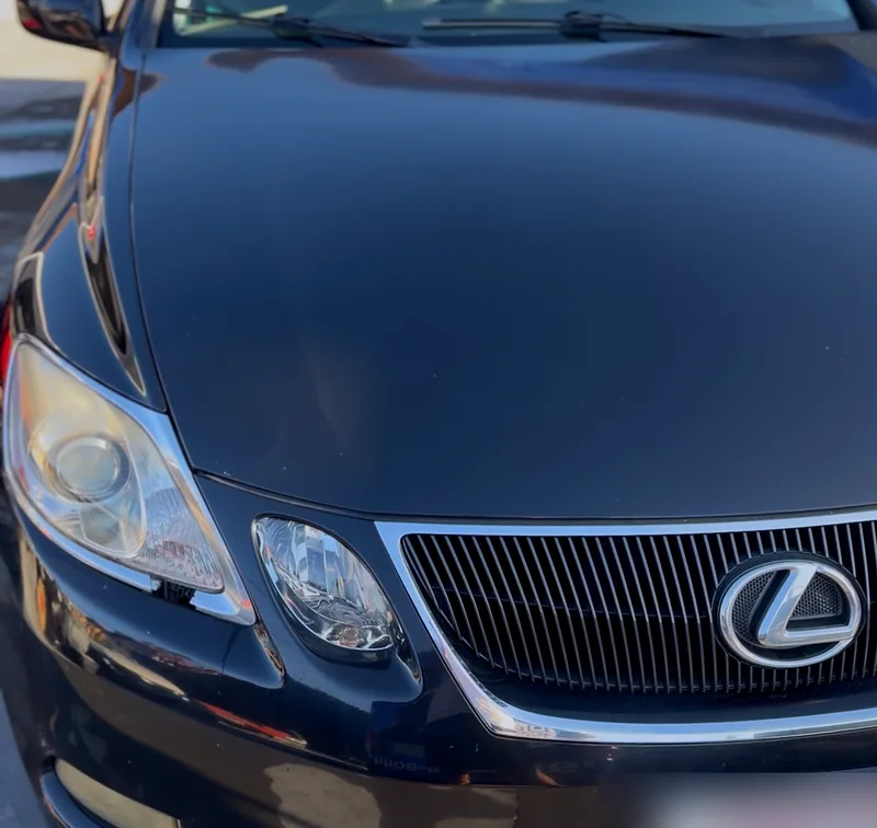 The same Lexus after detailing, the paint glossy and the chrome clean.