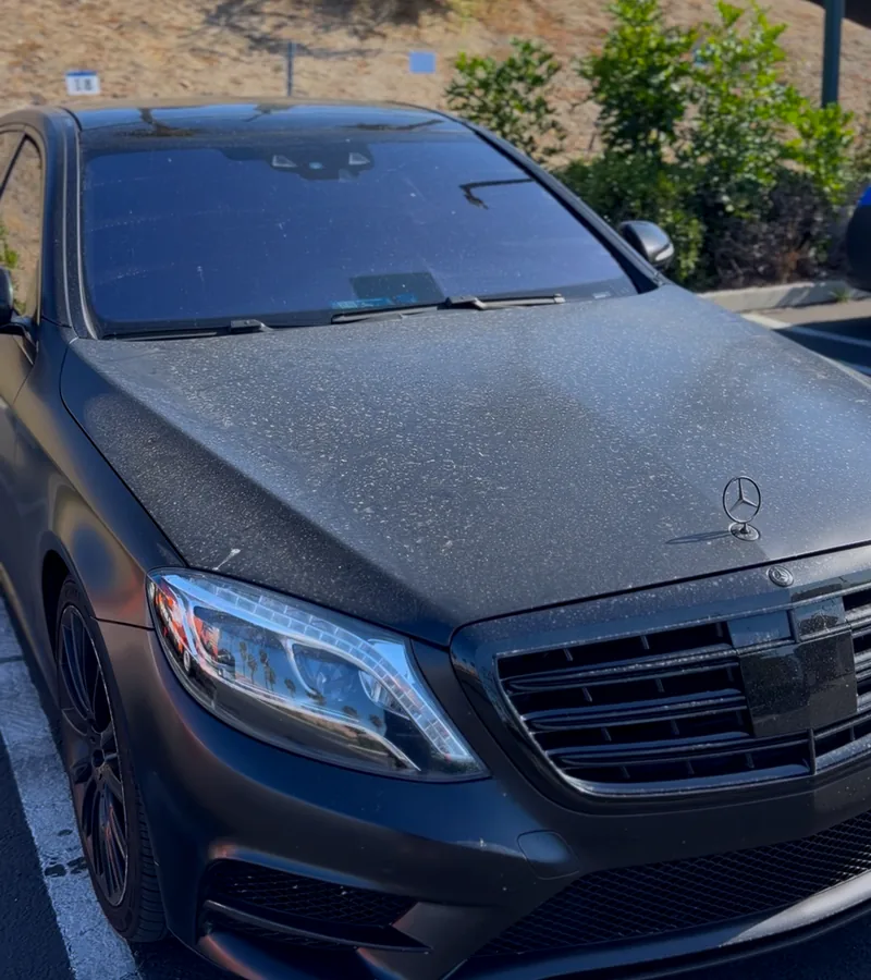 A satin grey Mercedes S63 covered in dust and water spots before washing.